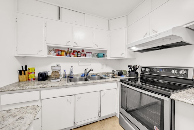 431 SW 1st Ave, Boynton Beach, FL 33435 - kitchen featuring stainless steel electric range, sink, white cabinetry, and light tile patterned floors