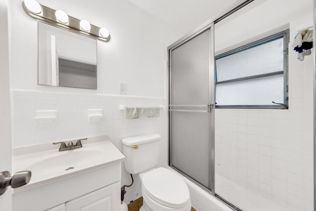 431 SW 1st Ave, Boynton Beach, FL 33435 - bathroom with tile walls, toilet, a shower with door, and vanity