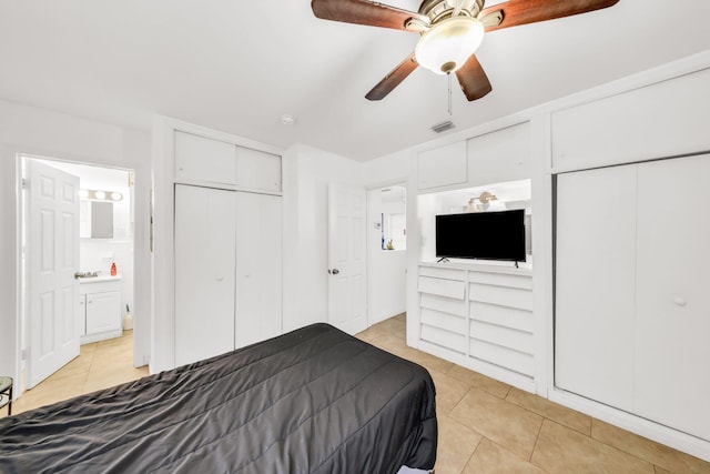 431 SW 1st Ave, Boynton Beach, FL 33435 - tiled bedroom featuring ceiling fan, two closets, and ensuite bathroom