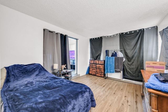 431 SW 1st Ave, Boynton Beach, FL 33435 - bedroom featuring a textured ceiling and wood-type flooring