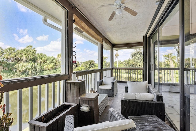 sunroom / solarium with a ceiling fan