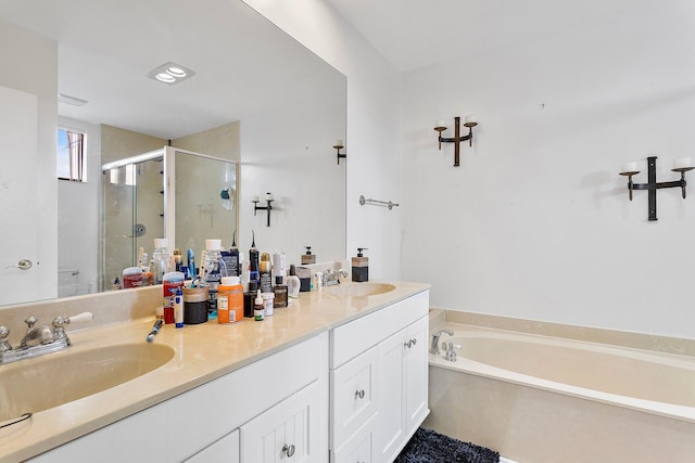 bathroom featuring double vanity, a stall shower, a sink, and a bath