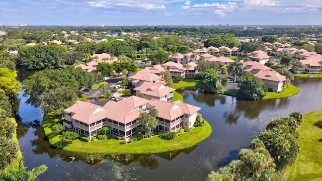 drone / aerial view featuring a residential view and a water view