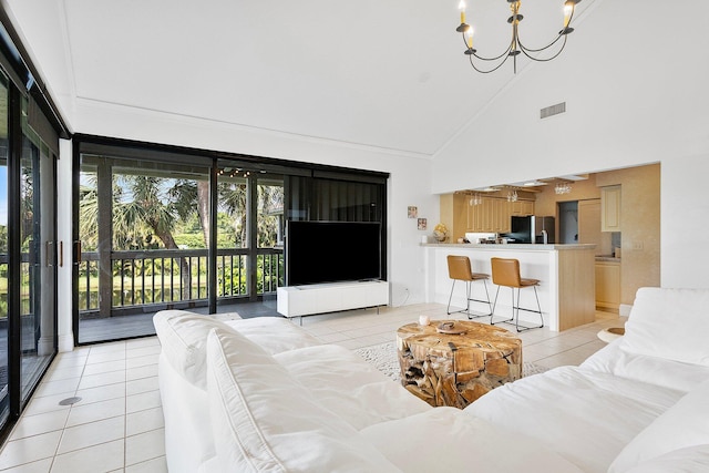 living room featuring high vaulted ceiling, light tile patterned floors, visible vents, and a notable chandelier