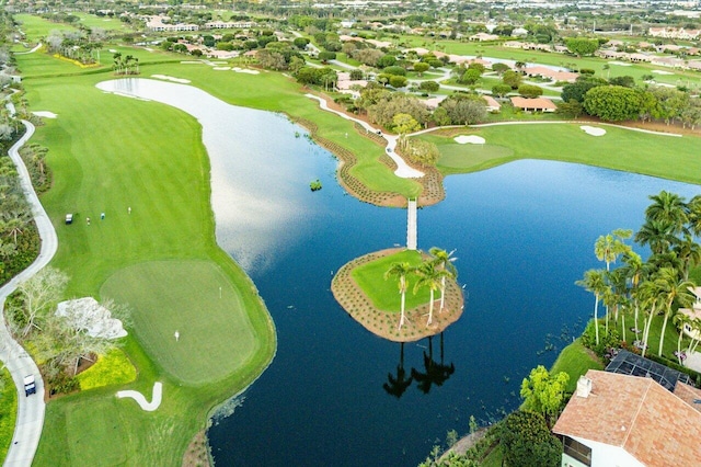 birds eye view of property featuring view of golf course and a water view