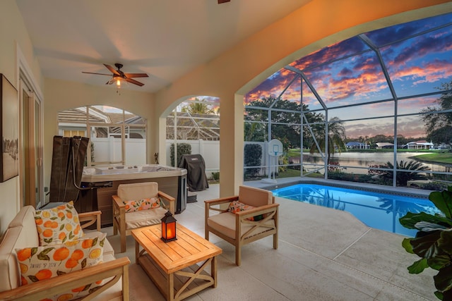 pool at dusk featuring an outbuilding, a lanai, a storage shed, area for grilling, and a patio area