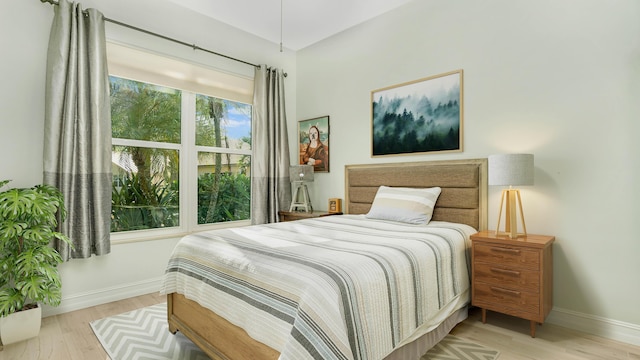 bedroom featuring baseboards and wood finished floors