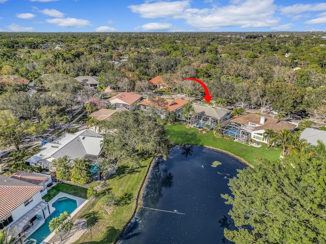 birds eye view of property featuring a water view, a view of trees, and a residential view