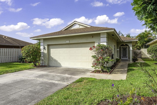 ranch-style house featuring driveway, an attached garage, fence, a front lawn, and stucco siding