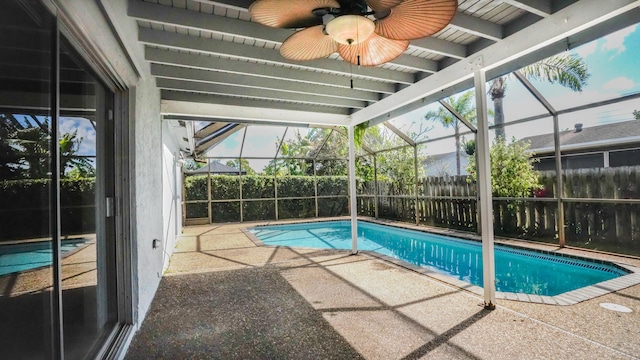 view of swimming pool with a patio, a fenced backyard, a lanai, a ceiling fan, and a fenced in pool