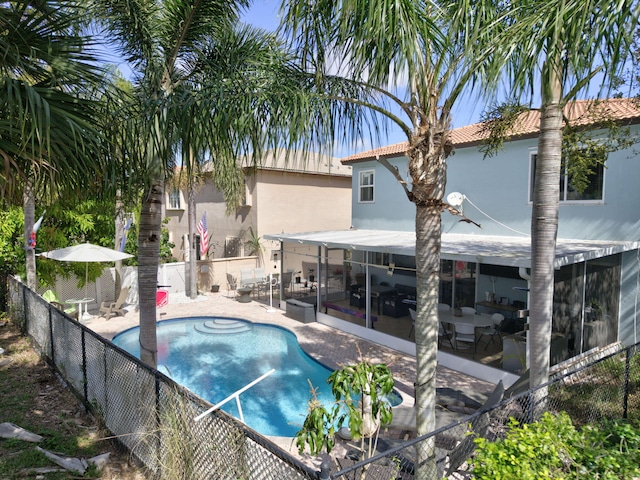 view of swimming pool with a patio area, fence, and a fenced in pool