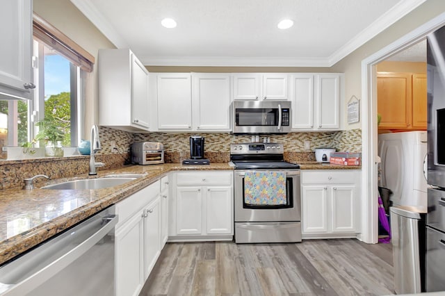 kitchen featuring white cabinetry, appliances with stainless steel finishes, and a sink