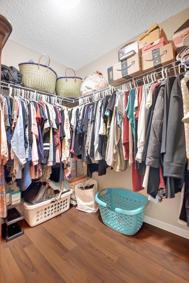 walk in closet featuring wood finished floors