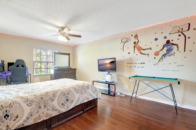 bedroom featuring dark wood-style floors, ceiling fan, a textured ceiling, and baseboards