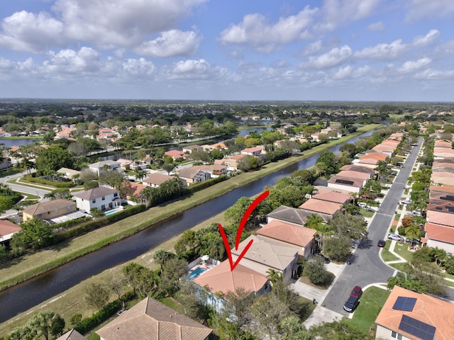 birds eye view of property with a water view and a residential view