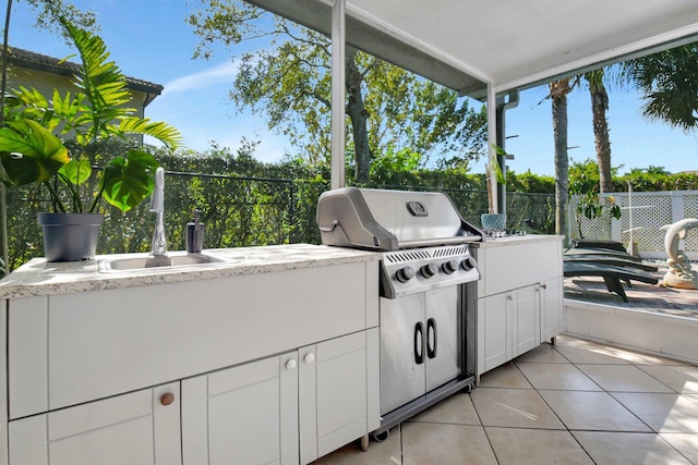view of patio / terrace with a sink, area for grilling, a grill, and fence