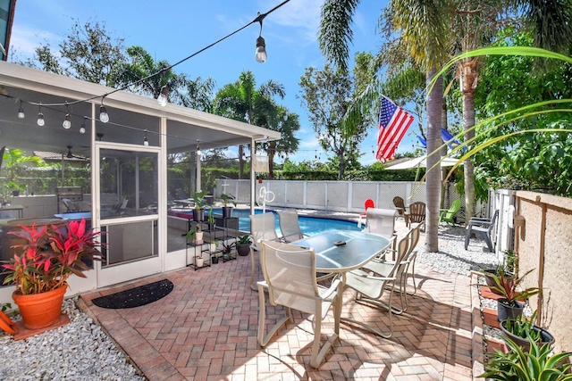 view of patio with a sunroom, a fenced backyard, and a fenced in pool