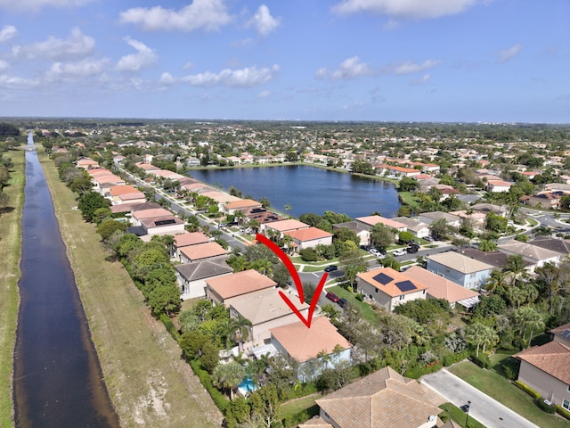 birds eye view of property with a residential view and a water view