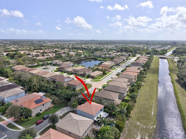 birds eye view of property with a water view and a residential view