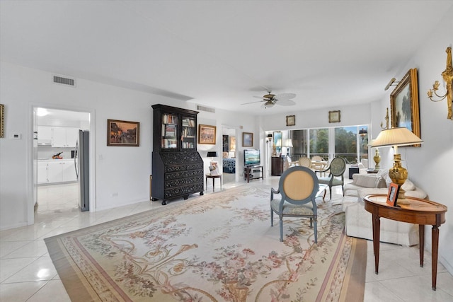 living room featuring ceiling fan and light tile patterned floors