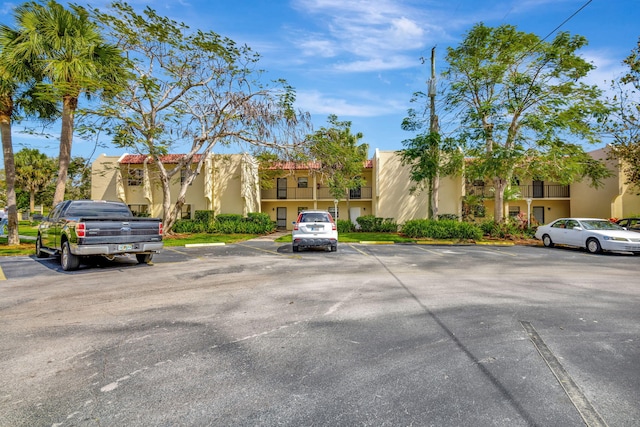 uncovered parking lot featuring a residential view