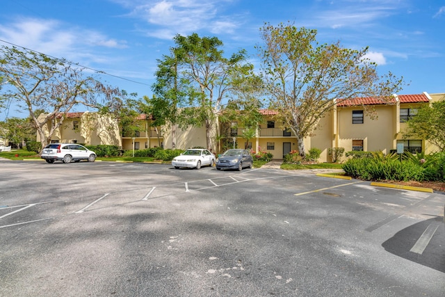 uncovered parking lot with a residential view