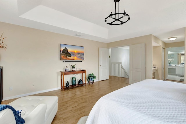 9602 Fox Trot Ln, Boca Raton, FL 33496 - bedroom featuring hardwood / wood-style flooring, a raised ceiling, and connected bathroom