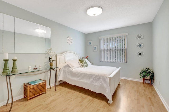 9602 Fox Trot Ln, Boca Raton, FL 33496 - bedroom featuring light hardwood / wood-style floors and a textured ceiling