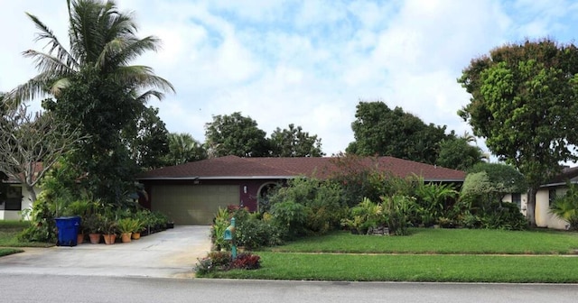 ranch-style home with a front yard and a garage