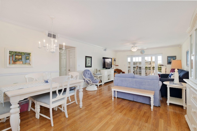 bedroom featuring a chandelier, light wood-style flooring, visible vents, french doors, and ornamental molding