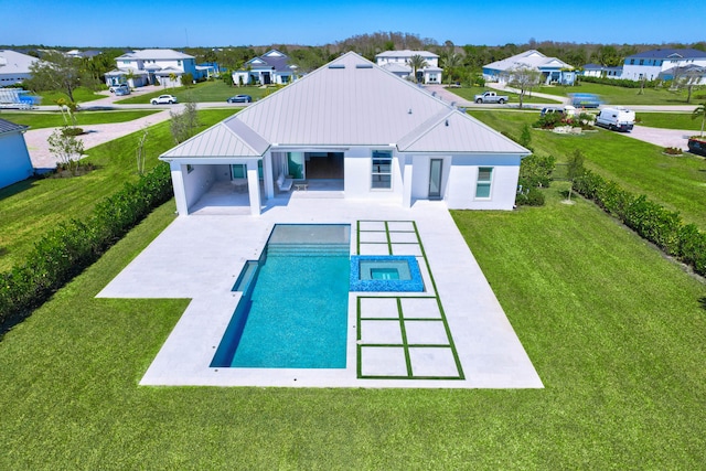 view of pool featuring a residential view, a lawn, a pool with connected hot tub, and a patio area