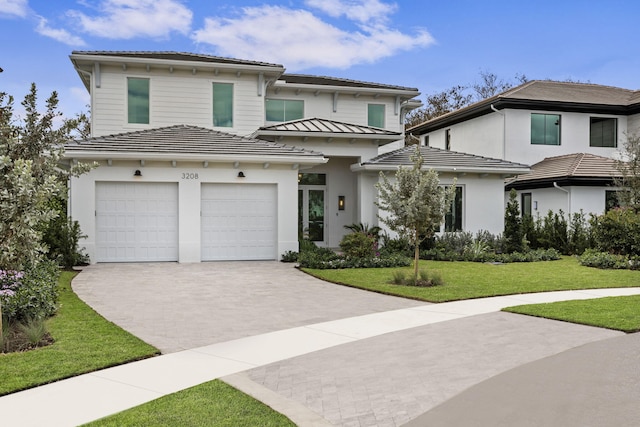 view of front facade with a garage and a front yard