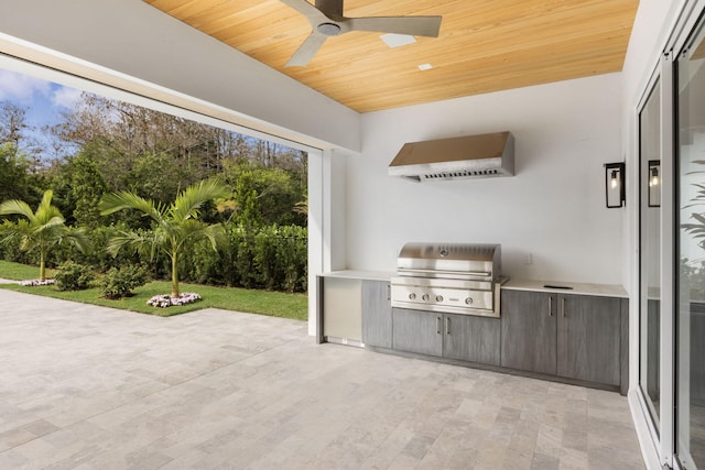 view of patio with ceiling fan, grilling area, and exterior kitchen