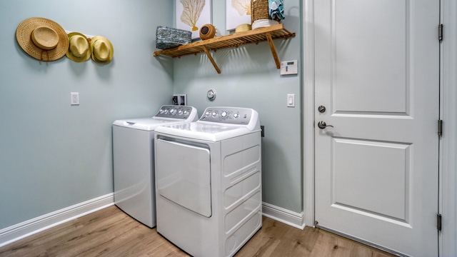 washroom with independent washer and dryer and light wood-type flooring