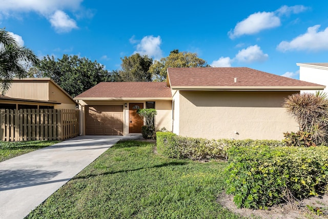 view of front of home with a garage and a front lawn