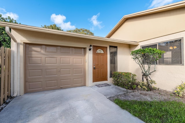 view of exterior entry with a garage