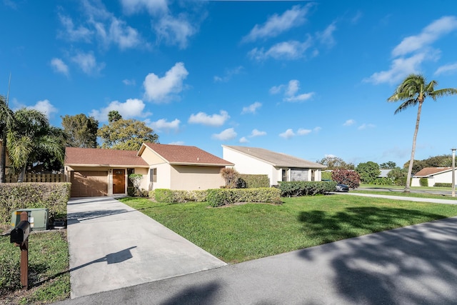 ranch-style house featuring a front yard and a garage