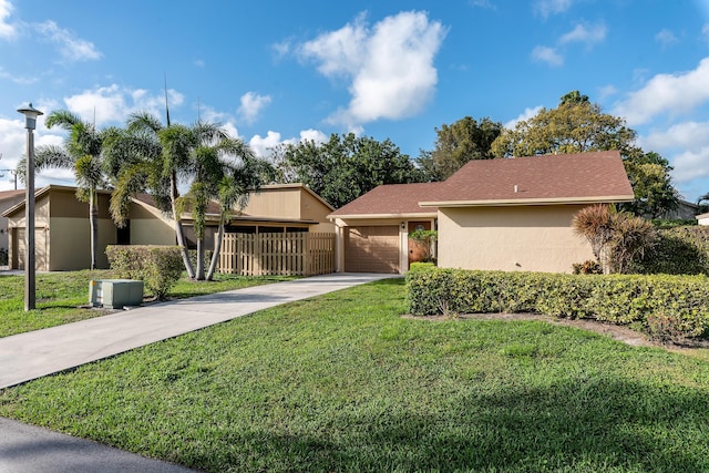 ranch-style home with a front lawn and a garage