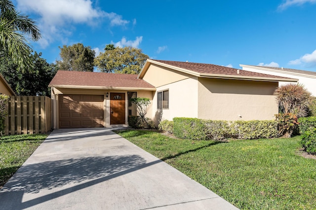 view of front of property featuring a front yard and a garage