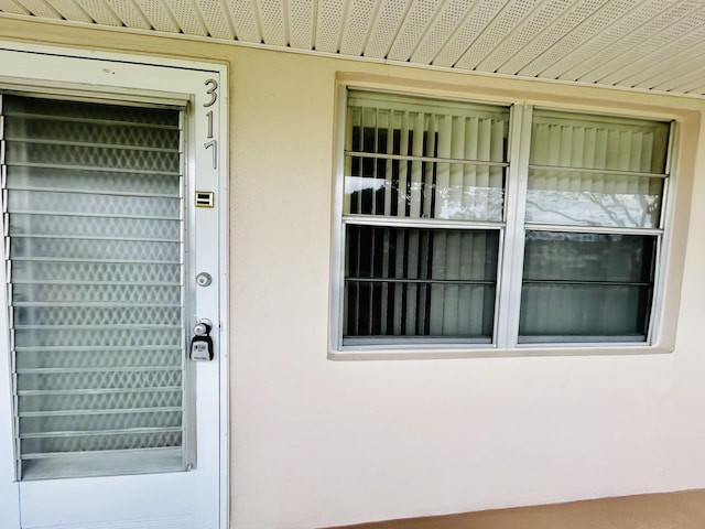 doorway to property with stucco siding