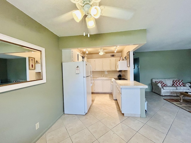 kitchen with light tile patterned flooring, white appliances, white cabinetry, open floor plan, and light countertops