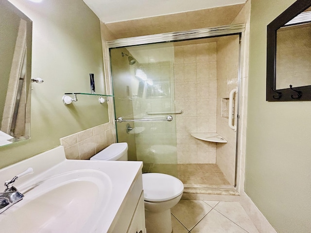 full bathroom featuring toilet, tile patterned floors, a shower stall, and vanity