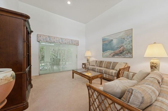 living area with light carpet and recessed lighting