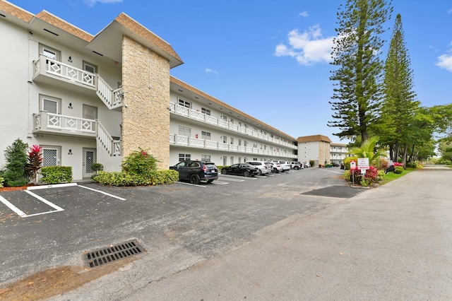 view of building exterior featuring uncovered parking