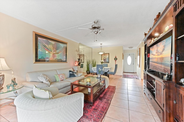 living room with light tile patterned floors, a textured ceiling, and a ceiling fan