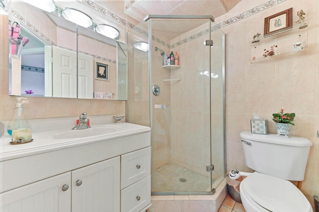 bathroom featuring a shower stall, tile walls, toilet, and vanity