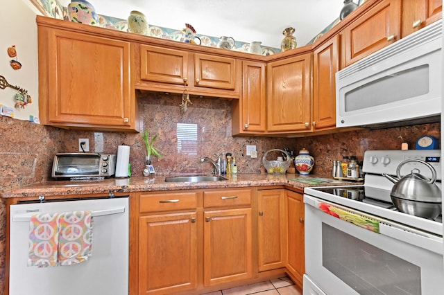 kitchen featuring white appliances, a toaster, a sink, and backsplash