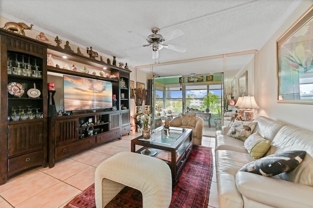 living area with a ceiling fan and light tile patterned floors