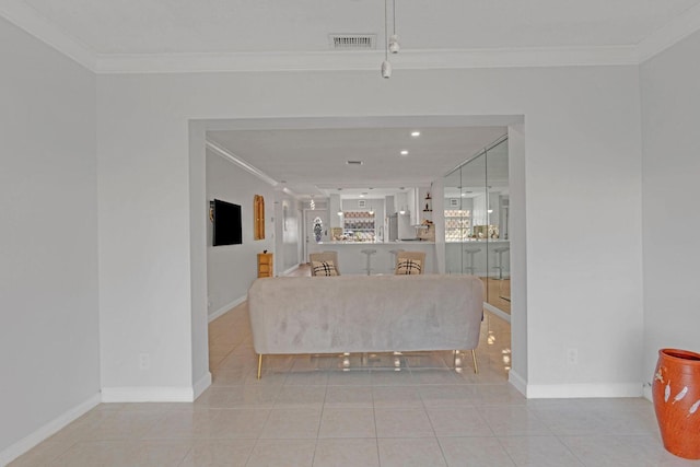 living room with light tile patterned floors, baseboards, visible vents, and crown molding