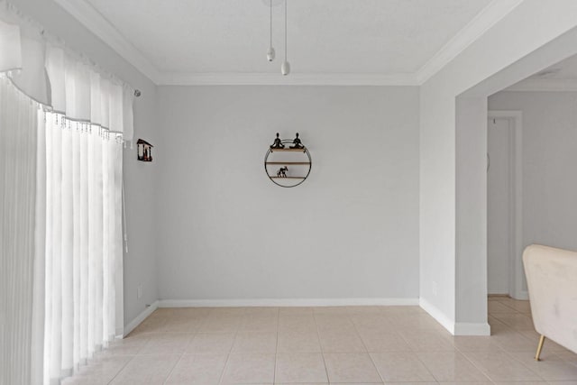 interior space featuring crown molding, baseboards, and light tile patterned floors